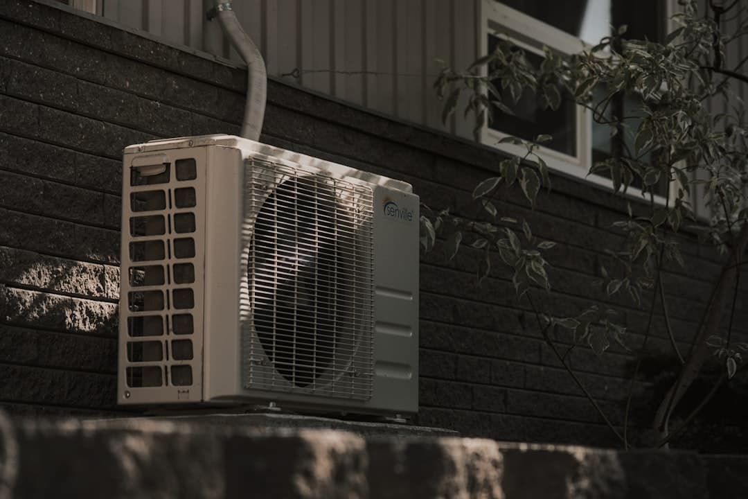 An outdoor condenser unit on a building exterior