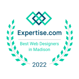 A badge from Expertise.com reading "Best Web Designers in Madison 2022." The design features a geometric logo at the top, the website name, and text encircled by green laurel branches. These badges highlight distinguished web designers in Madison.