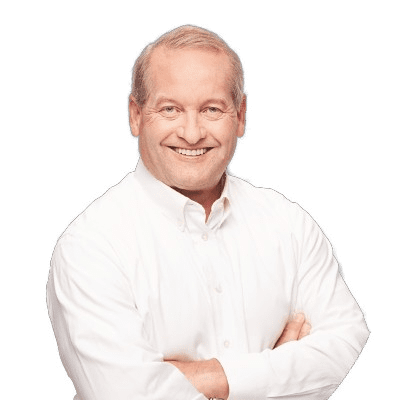 A smiling person with short, light-colored hair, wearing a white collared shirt, stands with arms crossed against a plain background, representing the innovative spirit of an asymmetric marketing agency based in Madison, WI.