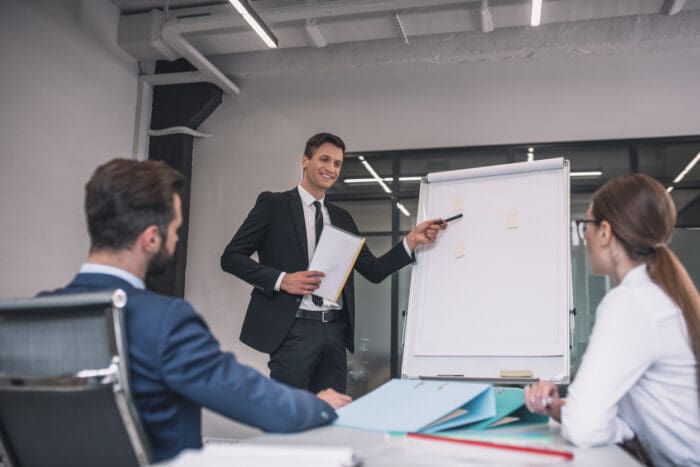 Business meeting with presentation on flipchart