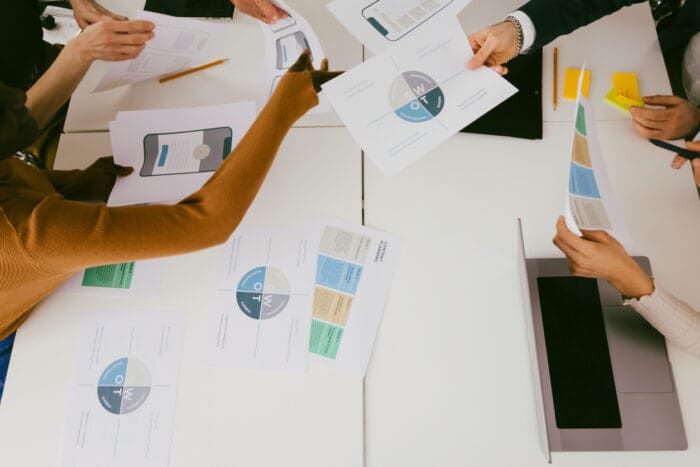 Team reviewing documents and planning strategies together.