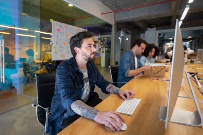 Busy office scene with employees at computers