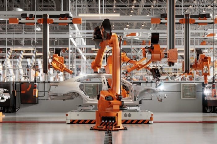 Robotic arms assembling cars in modern factory