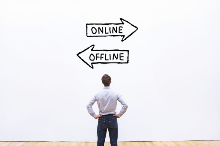 Person choosing between online and offline directions.