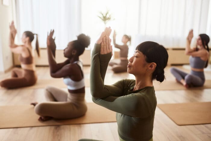 Diverse group practicing yoga in a serene studio