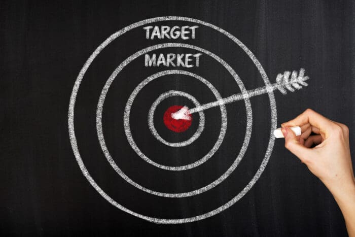 Target market concept with drawn bullseye and arrow.