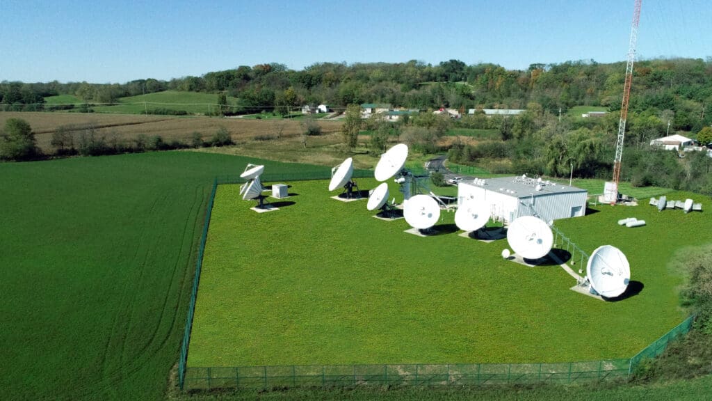 Aerial view of satellite dishes in rural landscape