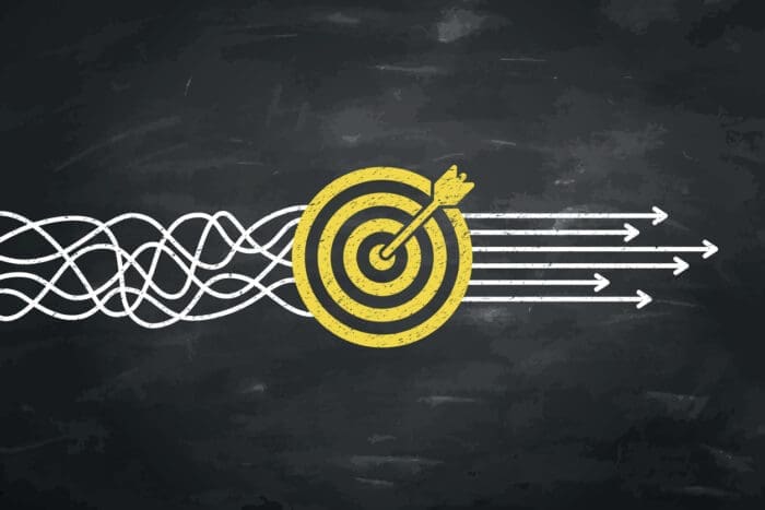 Chalkboard illustration of arrows hitting bullseye representing best practices in competitive benchmarking.