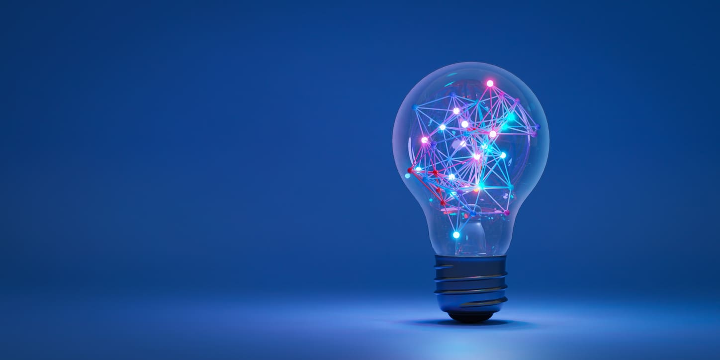 A light bulb against a blue background with colorful, glowing interconnected lines and nodes inside, resembling a network or circuitry, symbolizing innovation and business insight strategies.