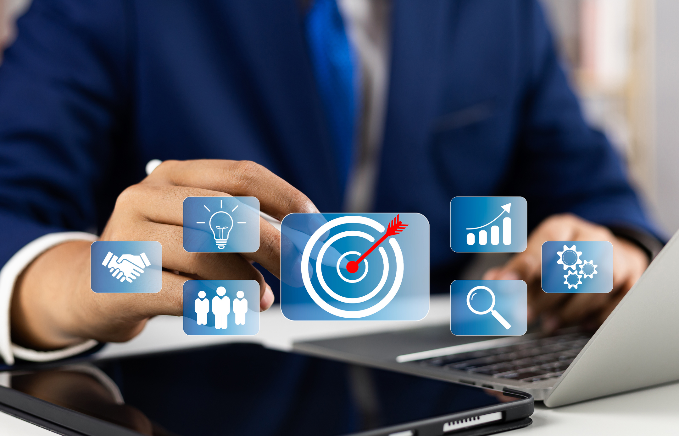 A person in a suit touches a virtual icon of a target with an arrow, symbolizing a goal. Other icons, representing Product Market Development (PMD), include a handshake, lightbulb, group of people, bar chart, and magnifying glass—denoting ideas, teamwork, success metrics, and search/research.