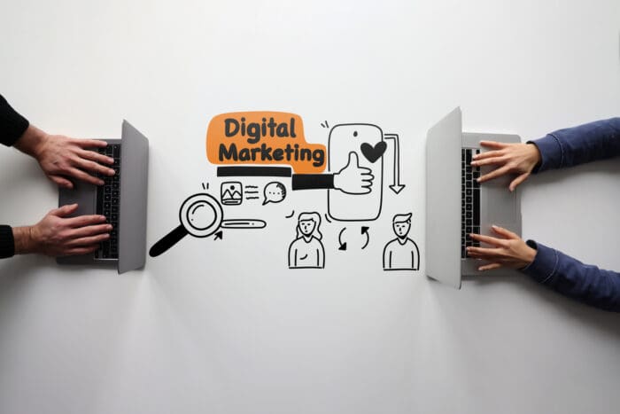 Digital marketing concept with laptops and illustrations.