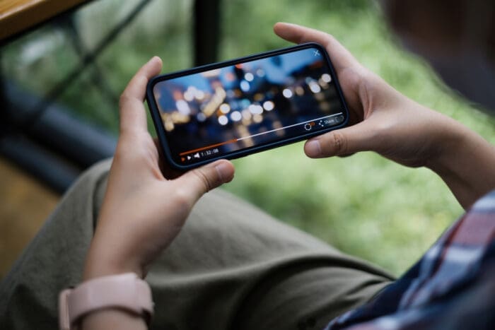 A user engaging with video content on a modern device.