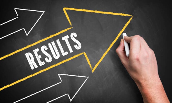 Results written with arrows on chalkboard