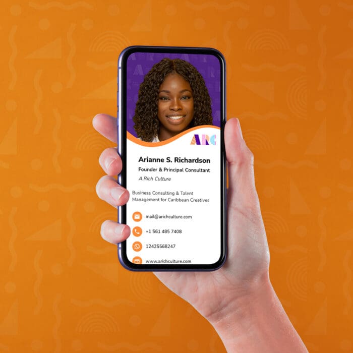 Hand holding smartphone displaying business contact card