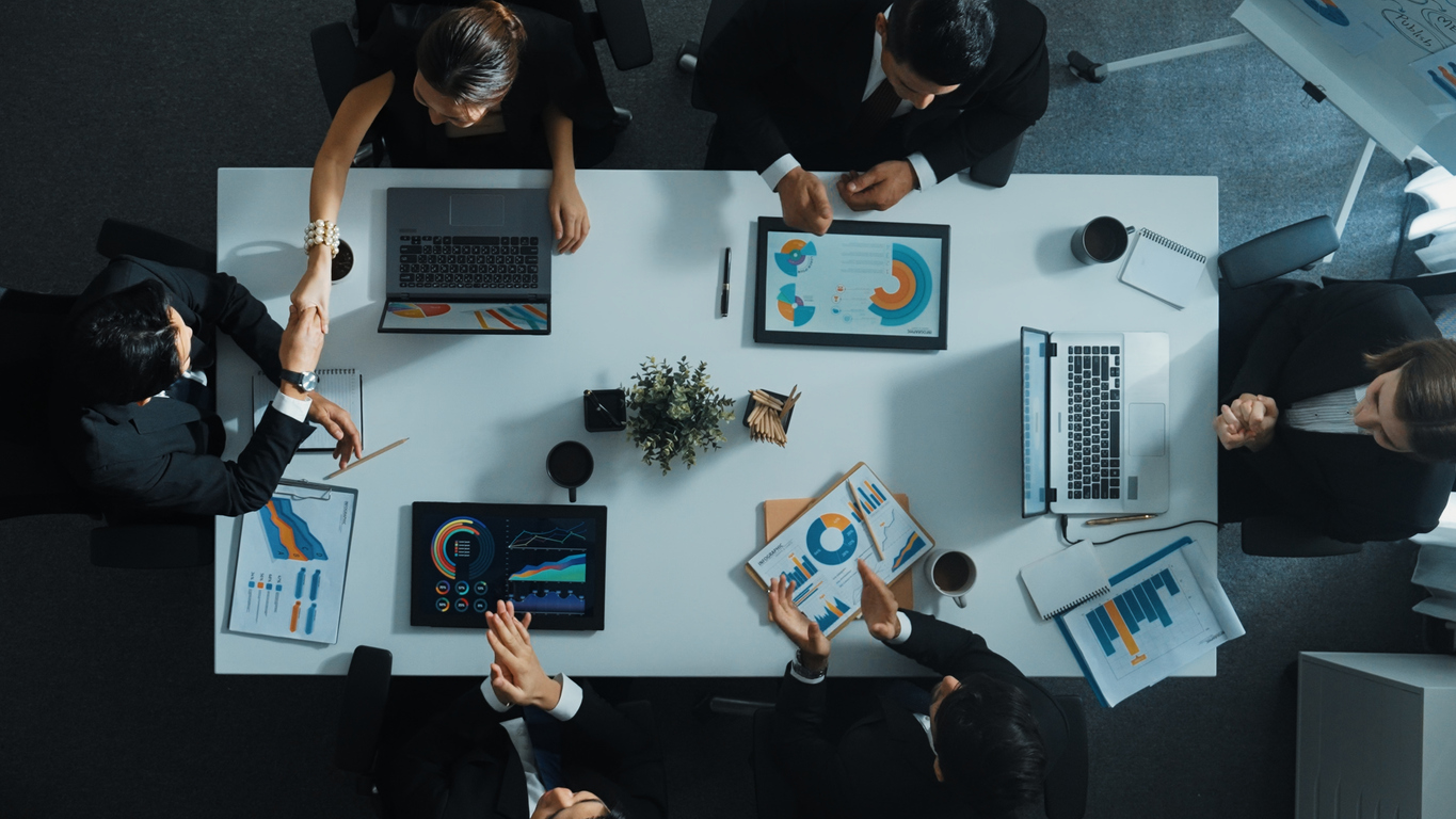 Business team collaborating around table with charts