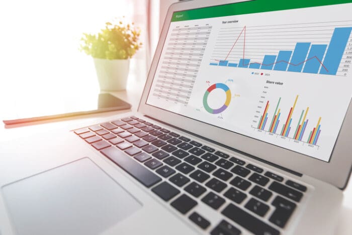 Laptop displaying colorful business analytics graphs