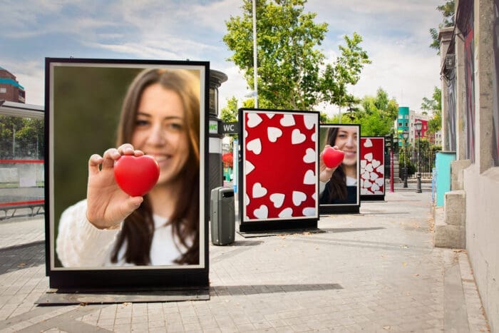 Woman holding heart, street billboards with similar images