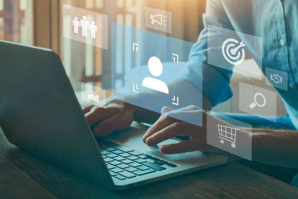Person typing on laptop with digital icons overlay