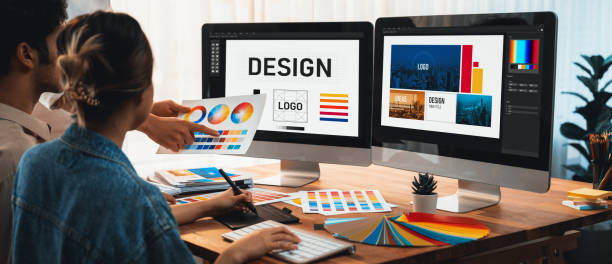 Designers collaborating on computer graphics and logos.