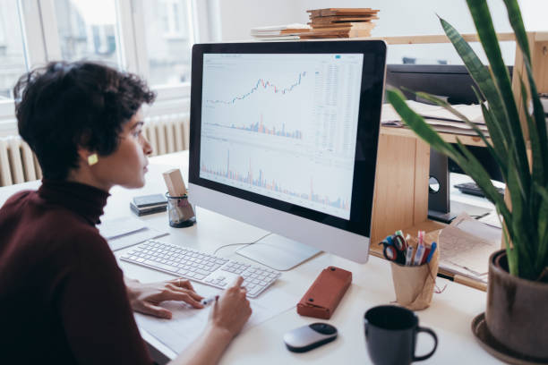 Analyst reviewing financial data on computer screen