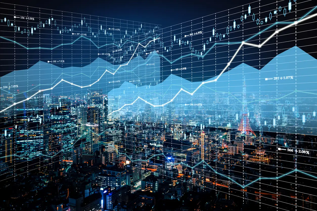 Cityscape with overlay of digital financial graphs