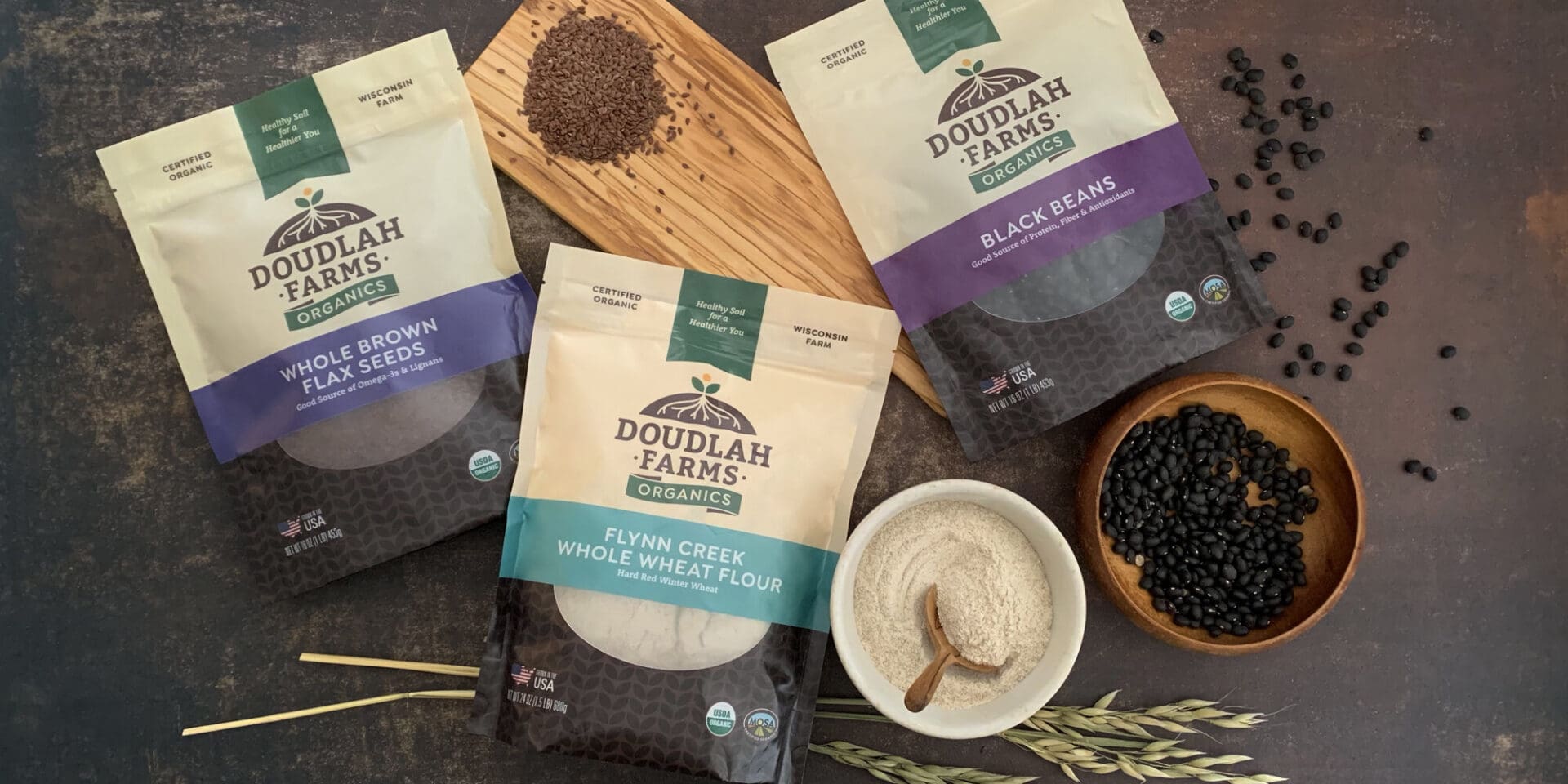 Organic flax seeds, wheat flour, and black beans packages.